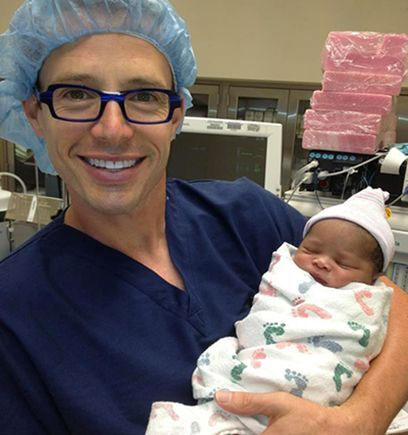 Picture of Dr. Grisham with a baby.
